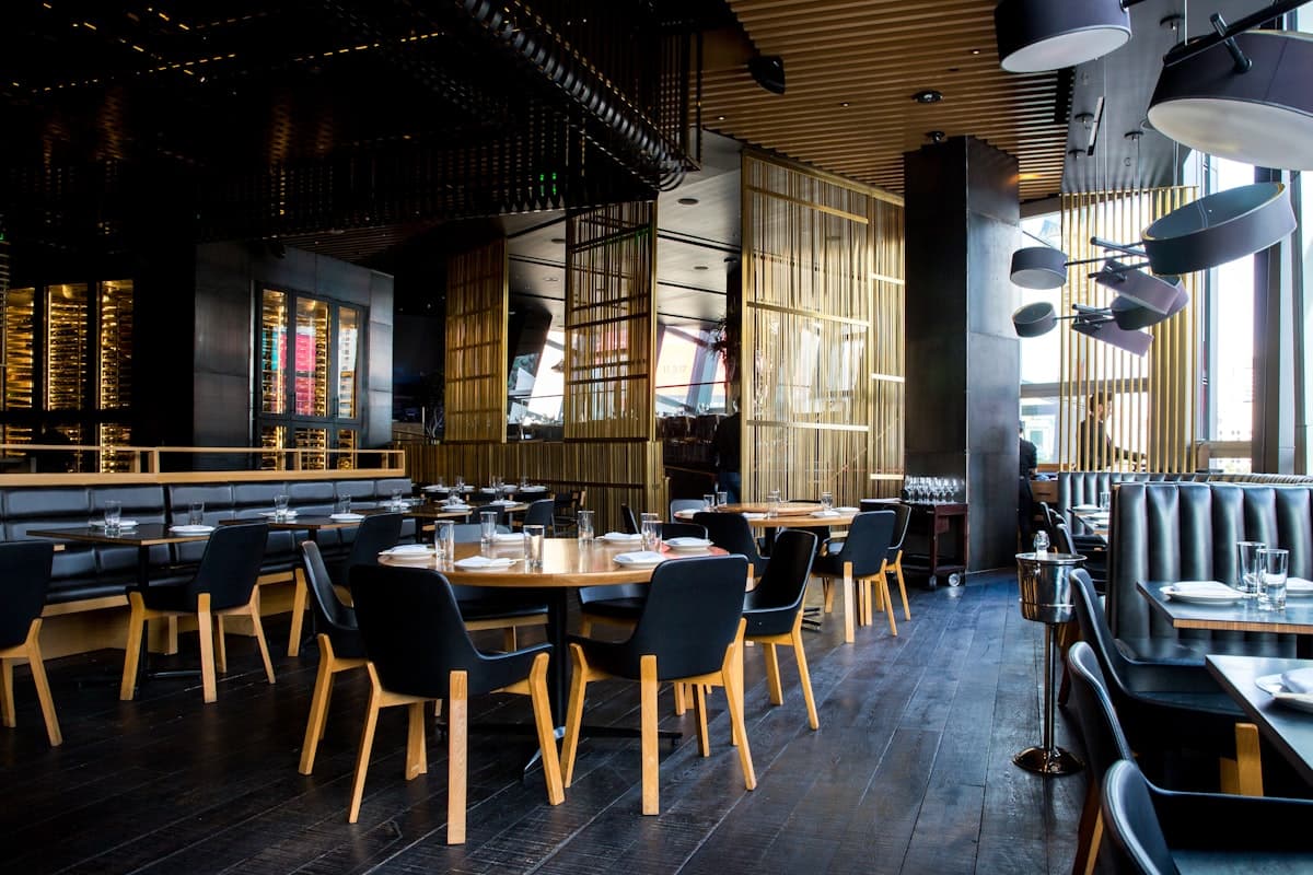Warm restaurant interior with tables set for dining